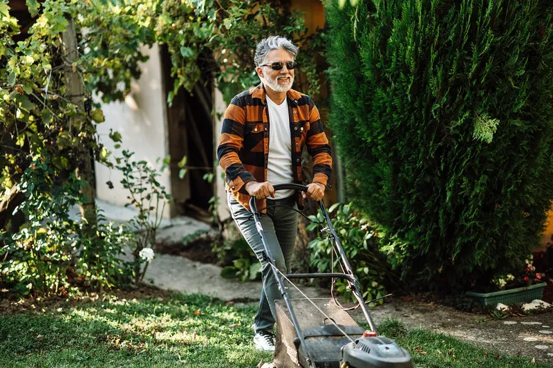 Landscaper mowing crisp stripes into a lawn